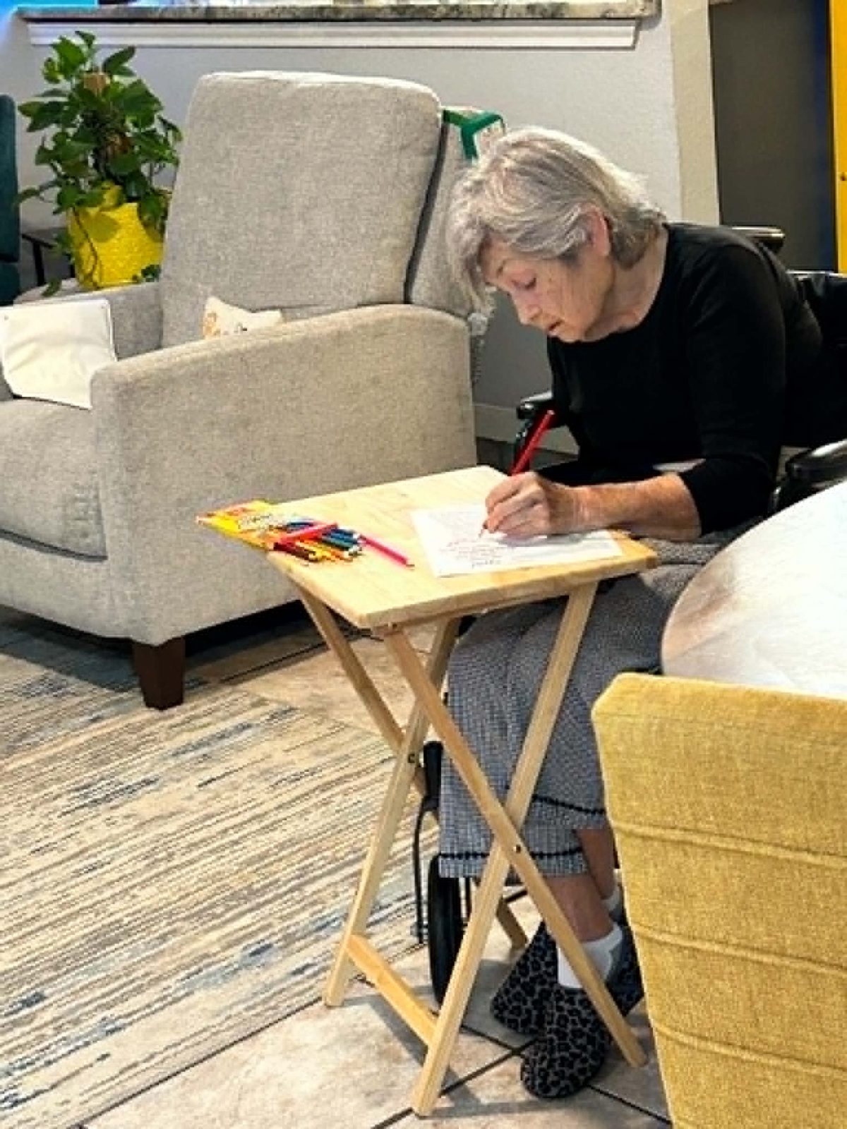 A resident enjoying a coloring activity